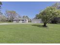 Attractive one-story home with a spacious lawn, complemented by a three car garage and mature landscaping at 1298 French Santee Rd, Jamestown, SC 29453