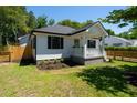 Charming home with black shutters, a cozy front porch, well-maintained lawn, and modern design at 1430 E Montague Ave, North Charleston, SC 29405