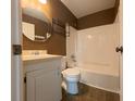 Cozy bathroom with a shower-tub combo, vanity, and a unique brown wall finish at 15 Town Park Ln # A, Charleston, SC 29412