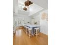Modern kitchen with a large central island, seating, and ample natural light from high ceilings and windows at 1634 Live Oak Park, Seabrook Island, SC 29455