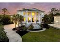 Beautiful two-story home with a circular driveway, manicured lawn, and prominent front columns at 1720 Bowline Dr, Mount Pleasant, SC 29466