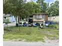 A house has outdoor seating under a tree in a grassy, fenced yard at 1902 Clifton St, North Charleston, SC 29406