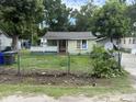 Quaint, single-story home with an enclosed front porch and fenced yard at 1902 Clifton St, North Charleston, SC 29406