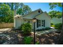 Charming home exterior with a bright turquoise front door, black shutters, and manicured landscaping at 2016 Wild Flower Ln, Charleston, SC 29414