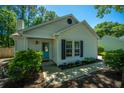 Charming home exterior with a bright turquoise front door and well-maintained landscaping at 2016 Wild Flower Ln, Charleston, SC 29414