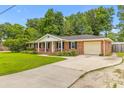 Well-maintained brick home with a concrete driveway and an attached garage at 2045 Vestry Dr, Charleston, SC 29414