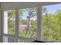 View from the screened porch showing the marsh, maritime forest and another home at 2333 Tall Sail Dr # G 607, Charleston, SC 29414