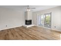 This living room features a fireplace, wood floor and sliding glass door to the outside at 2333 Tall Sail Dr # G 607, Charleston, SC 29414