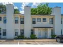 Inviting townhouse with light yellow siding, complemented by lush green bushes and ample parking at 235 Pine Shadow Dr, Goose Creek, SC 29445