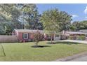 Charming single-story brick home with a well-manicured front lawn and trees at 25 Aldene Ave, Goose Creek, SC 29445