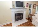 Close up of a cozy fireplace with white mantel, tile details and mounted tv at 2613 Rivertowne Pkwy, Mount Pleasant, SC 29466