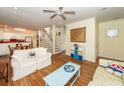Cozy living room with hardwood floors, a ceiling fan, and staircase at 2613 Rivertowne Pkwy, Mount Pleasant, SC 29466
