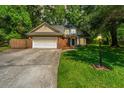 Traditional-style brick home with an attached two-car garage and a green, tree-lined yard at 2650 Summer Leaves Ct, Charleston, SC 29414