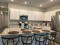 Bright kitchen features a large island with seating and modern appliances at 305 Camellia Bloom Dr, Moncks Corner, SC 29461