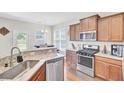 Well-equipped kitchen with granite countertops, stainless steel appliances, and wood cabinets at 308 Legendres Dr, Goose Creek, SC 29445