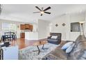 Open-concept living room with hardwood floors, modern furniture, and a ceiling fan at 308 Legendres Dr, Goose Creek, SC 29445