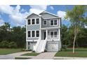 Charming two-story home with a inviting front porch, featuring a classic exterior, set amidst lush greenery at 3139 Vanessa Lynne Ln, Johns Island, SC 29455