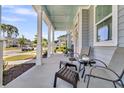 A relaxing front porch features comfortable seating and a tranquil view of the neighborhood street at 3529 Habenaria Rd # 33, Mount Pleasant, SC 29466