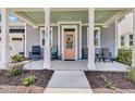 A welcoming front porch of a single-story home features comfortable seating and tasteful landscaping at 3529 Habenaria Rd # 33, Mount Pleasant, SC 29466