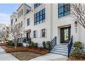 Elegant townhouse entrance with a welcoming porch, steps, and manicured shrubbery at 405 Spartina Ln # 405, Charleston, SC 29492