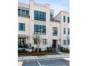 Attractive multi-story townhouses with large dark-framed windows, manicured yard, and stylish architecture at 405 Spartina Ln # 405, Charleston, SC 29492