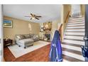 Inviting living room with hardwood floors, a cozy fireplace, and stairway access to the upper level at 4662 Nibbs Ln, North Charleston, SC 29418