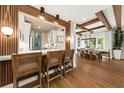 Kitchen with breakfast bar open to a dining area with exposed beam ceiling at 4943 Green Dolphin Way, Kiawah Island, SC 29455