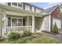 Inviting front porch with white railings and lush landscaping for added curb appeal at 4987 Ballantine Dr, Summerville, SC 29485