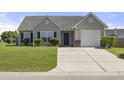 Charming single-story home with a well-maintained lawn, siding, and an attached one-car garage at 5040 Thornton Dr, Summerville, SC 29485