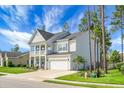 Well-maintained home with an attached two-car garage, manicured lawn, and a cozy front porch at 523 Kilarney Rd, Summerville, SC 29483