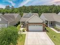 A beautiful home with a stone and siding front, well-maintained landscaping, and a spacious driveway at 548 Sea Foam St, Summerville, SC 29486