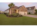Charming brick home with a lush lawn, complemented by a stately palm tree at 627 Chigwell Springs Ln, Summerville, SC 29486