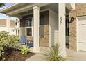 Inviting front porch features comfortable seating and charming curb appeal at 627 Chigwell Springs Ln, Summerville, SC 29486