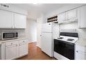 Functional kitchen area with appliances, white cabinets and wood floors at 700 Daniel Ellis Dr # 11302, Charleston, SC 29412