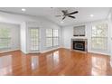 Bright living room with fireplace, wood floors, ceiling fan and natural light at 700 Daniel Ellis Dr # 11302, Charleston, SC 29412
