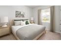 Serene bedroom with a striped bed, decorative pillows, and natural light streaming through the window at 744 Meadowbrook Ln, Summerville, SC 29486