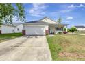Inviting single-story home featuring an attached garage, driveway, and a quaint front porch at 7838 Long Shadow Ln, North Charleston, SC 29406