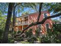 Charming two-story home with covered balconies, surrounded by lush greenery at 82 Ponsbury Rd, Mount Pleasant, SC 29464