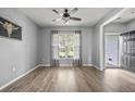 Bright living room with gray walls, wood floors, natural light, and neutral tones at 9009 Chato Ct, Summerville, SC 29483