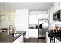 Bright kitchen featuring granite countertops, stainless steel appliances, and ample cabinet space at 9694 Roseberry St, Ladson, SC 29456