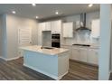 Modern kitchen featuring stainless steel appliances, white cabinets, and a center island at 1035 Tulip Shell St, Summerville, SC 29485