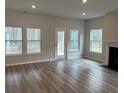 Sunlit living room boasts beautiful flooring, neutral paint, and a cozy fireplace at 1035 Tulip Shell St, Summerville, SC 29485