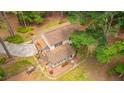 Aerial view of a home with a brick facade and a screened-in back porch in a wooded area at 110 Cantering Hills Ln, Summerville, SC 29483