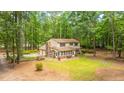 Two-story home boasting a two-car garage, screened-in porch, and lush green lawn surrounded by tall trees at 110 Cantering Hills Ln, Summerville, SC 29483