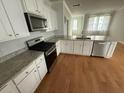 Modern kitchen featuring white cabinets, granite countertops, and stainless steel appliances at 111 Brant Dr, Summerville, SC 29483