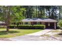 Classic brick home with well-kept landscaping, a covered carport, and a spacious front yard at 113 Overhill Dr, Walterboro, SC 29488