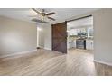Open-concept living space with luxury vinyl flooring and a sliding barn door at 121 Harrison St, Varnville, SC 29944