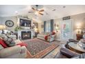 Cozy living room with fireplace, ceiling fan, and comfortable seating area at 127 Travis Hill Rd, Moncks Corner, SC 29461