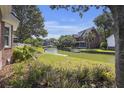 Scenic backyard view featuring a canal, lush greenery, and a charming home with a private dock at 1280 Waterfront Dr, Mount Pleasant, SC 29464