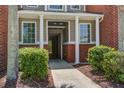 Inviting entrance to a condo with decorative columns, address numbers, and lush green landscaping at 1335 Hopton Cir # 1335, Mount Pleasant, SC 29466